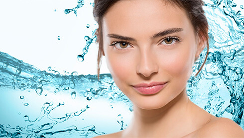 Woman's face with water splashing background